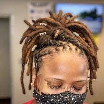 picture of a black woman with brown dreadlocks